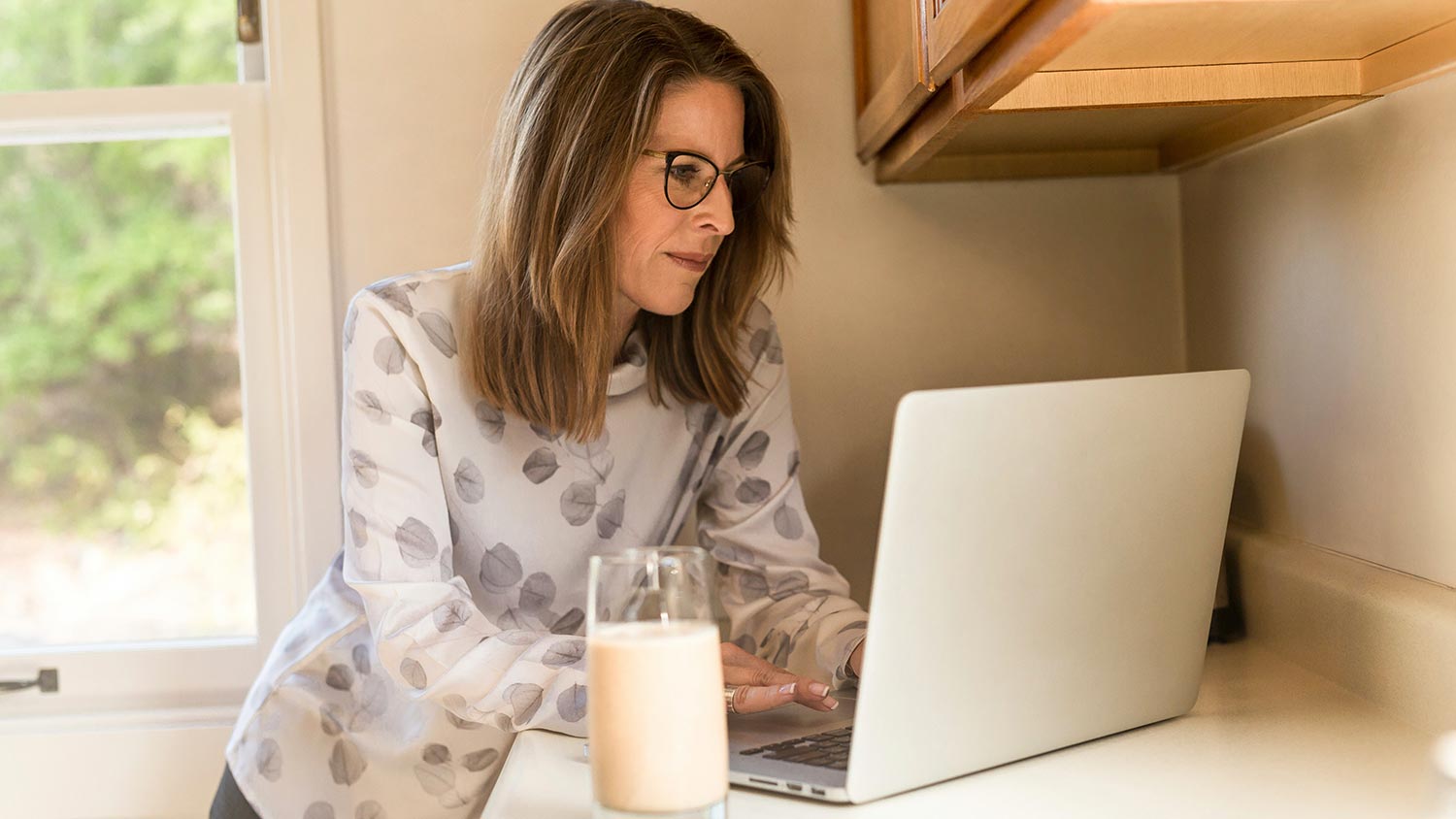 Woman with a baby working on a computer