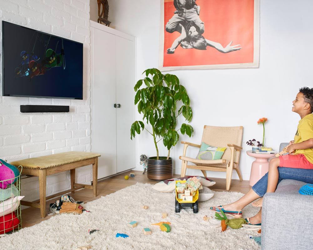 Kid watching tv in a play room with a sonos soundbar
